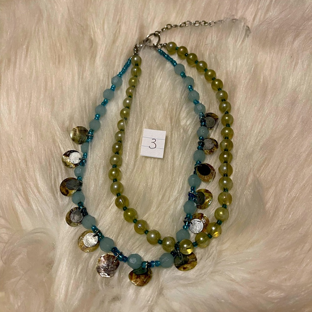 Double string one with clear blue beads and the other with blue beads and shells